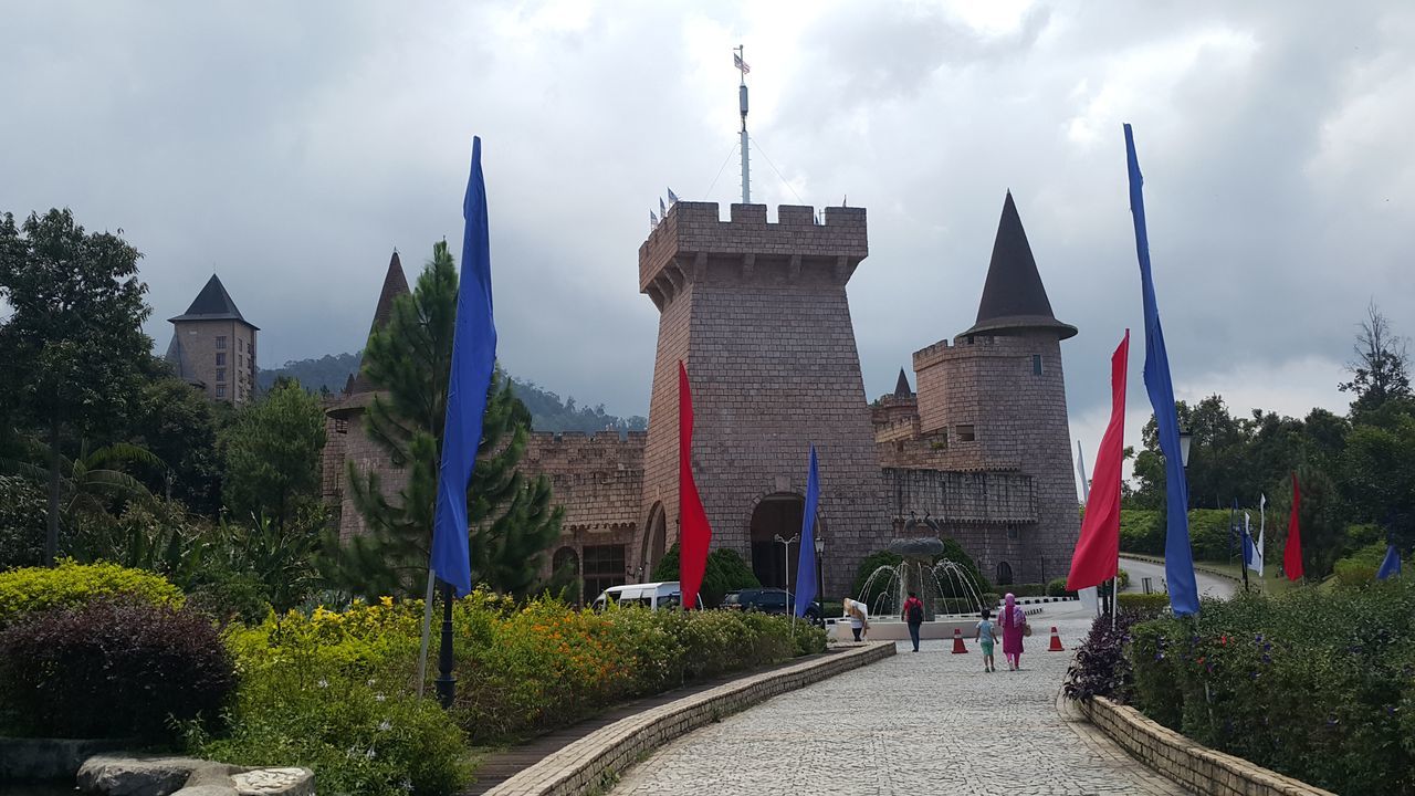 architecture, built structure, sky, building exterior, cloud, tourism, landmark, building, nature, travel destinations, city, plant, flag, history, the past, travel, tree, castle, tower, château, street, transportation, town, outdoors, religion, panoramic, landscape, park, group of people, place of worship