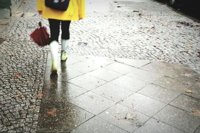 Woman walking on sidewalk