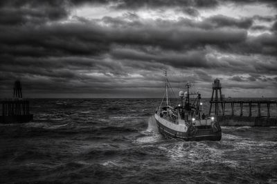 Boat sailing on sea against sky