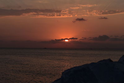 Scenic view of sea against romantic sky at sunset