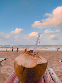 Close-up of chocolate on beach against sky