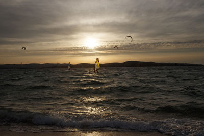 Scenic view of a windsurf on sea against sky during sunset