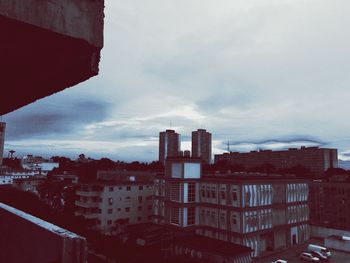 Buildings against cloudy sky