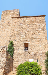 Low angle view of old building against clear sky