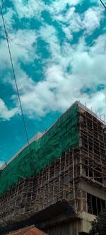 Low angle view of building under construction against sky