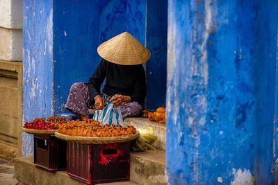 Rear view of man wearing hat at market stall