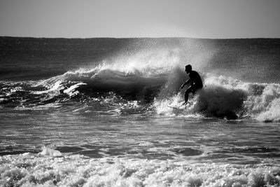 People surfing in sea