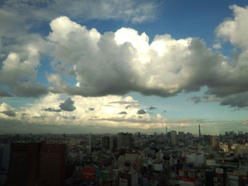 Buildings against cloudy sky