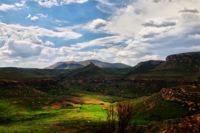 Scenic view of mountains against cloudy sky