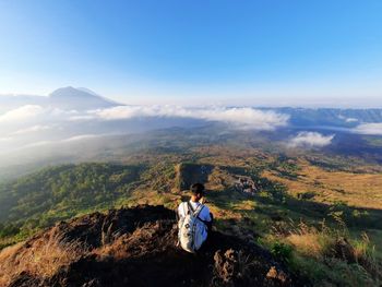 Man standing on mountain against sky