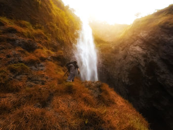 Scenic view of waterfall on mountain