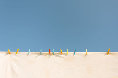 Sand dune on beach against clear blue sky