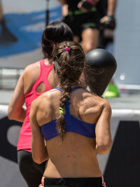 Rear view of women walking in swimming pool