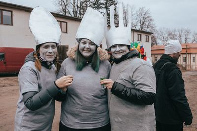 People standing outside house during winter