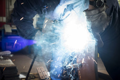 Blurred motion of man working on metal