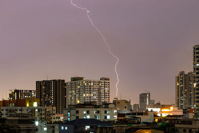 Aerial view of illuminated city against sky at night