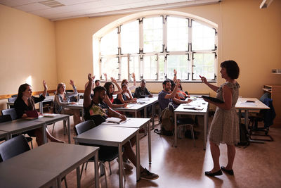 Teacher asking questions to students in language school