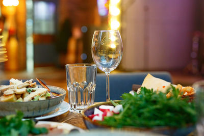 Close-up of wine glasses on table