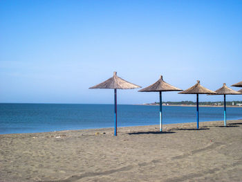 Lifeguard hut on beach against clear sky