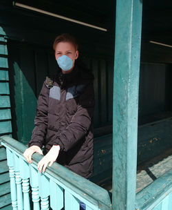 Young man sitting on railing