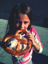 Portrait of girl eating pretzel