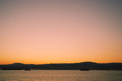 Scenic view of sea against romantic sky at sunset