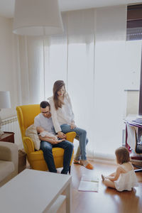 Side view of mother and daughter at home