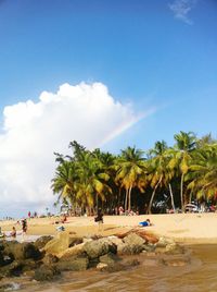 People on beach against sky