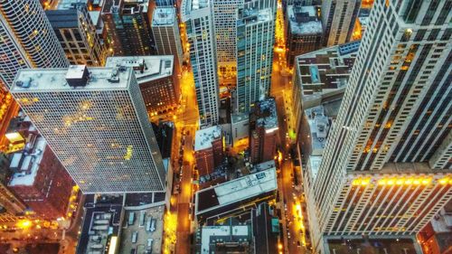 High angle view of illuminated modern buildings during sunset
