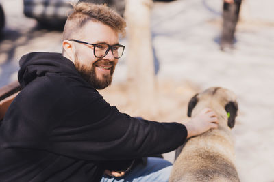 Portrait of man holding dog