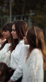 Rear view of people looking at camera