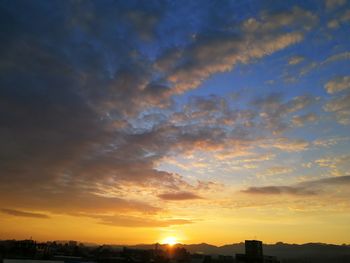 Silhouette buildings against sky during sunset
