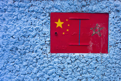 Close-up of red mailbox on wall