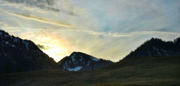 Scenic view of mountains against cloudy sky