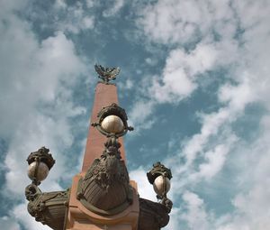 Low angle view of statue against cloudy sky