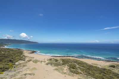 Scenic view of beach against blue sky