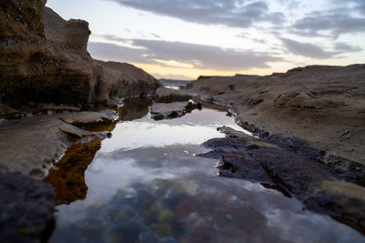 Scenic view of rocks against sky during sunset