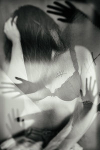 Double exposure image of woman in lingerie with hands