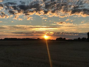 Scenic view of field against sky during sunset