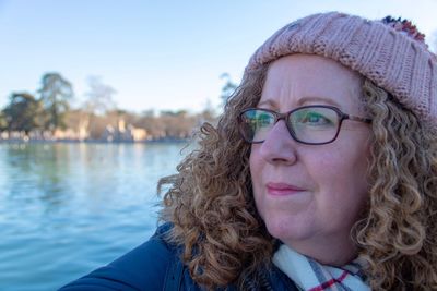 Close-up portrait of woman with reflection in water