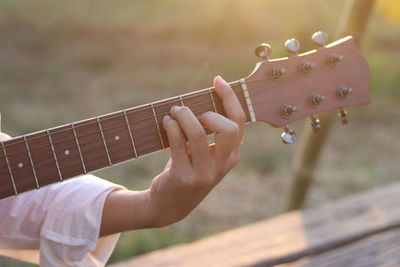 Cropped hand playing guitar