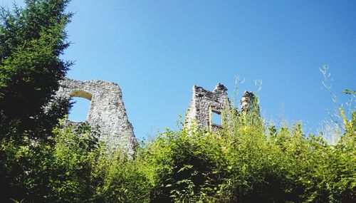 Low angle view of old building against clear blue sky