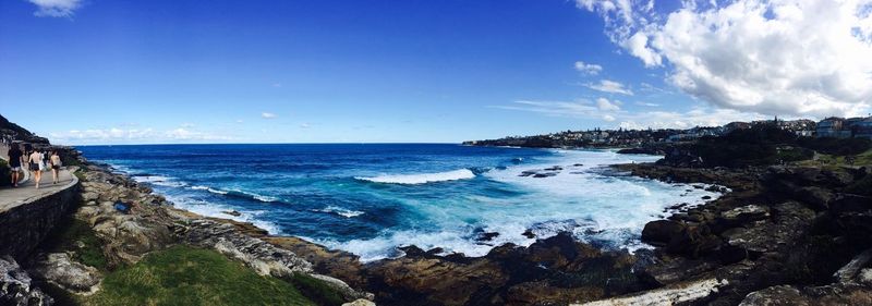 Panoramic view of sea against blue sky