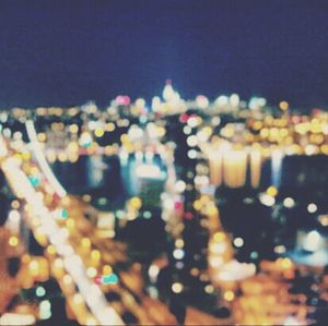 Defocused image of illuminated city at night