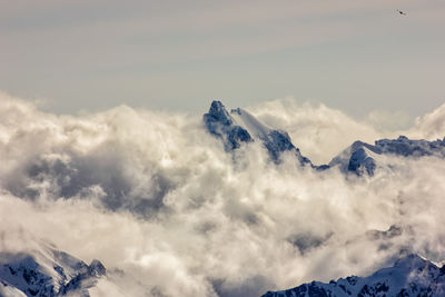 Low angle view of snowcapped mountains against sky