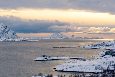 Scenic view of frozen lake against sky during sunset