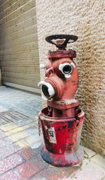 Close-up of fire hydrant against wall