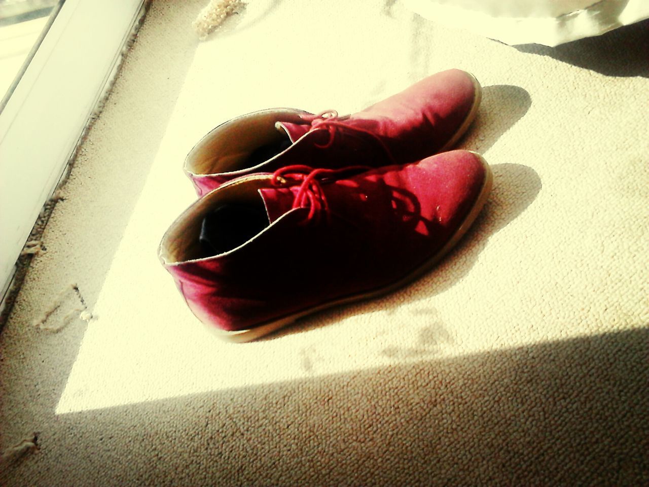 red, indoors, high angle view, shadow, table, pink color, close-up, sunlight, flooring, still life, day, low section, tiled floor, no people, street, floor, part of, sidewalk