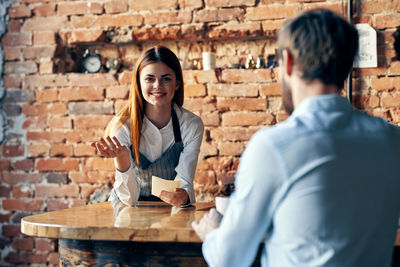 Rear view of couple sitting at table