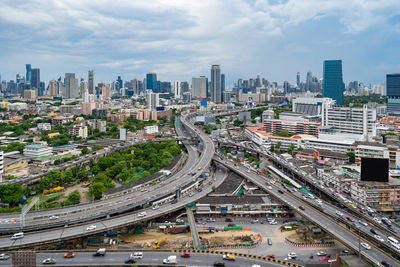 High angle view of vehicles on road amidst buildings in city